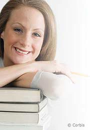 Young woman smiling leaning chin on books